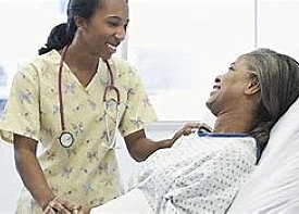 woman with stethoscope touching the hand and shoulder of an old woman patient